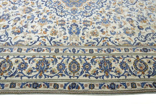 Corner detail of 2000s Kashan rug showing border pattern and Wool pile