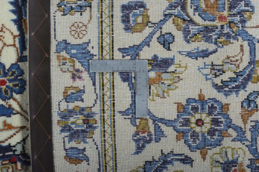 Backside of handmade 2000s Kashan rug showing knot structure and weave density