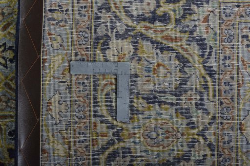 Backside of handmade New Kashan rug showing knot structure and weave density