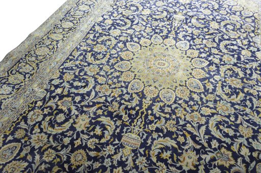 Backside of handmade New Kashan rug showing knot structure and weave density