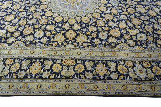 Corner detail of 2000s Kashan rug showing border pattern and Wool pile