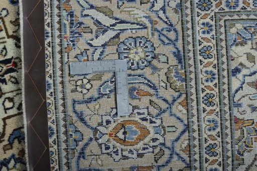 Backside of handmade New Kashan rug showing knot structure and weave density