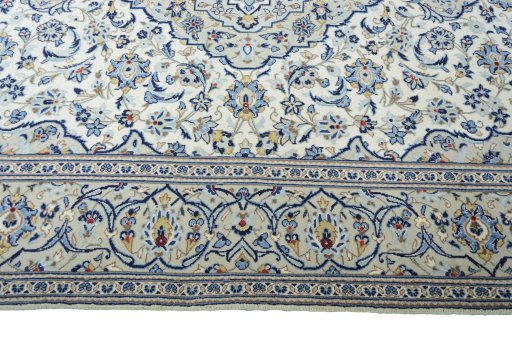Corner detail of 2000s Kashan rug showing border pattern and Wool pile
