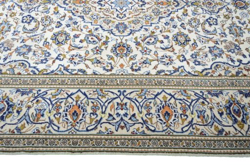 Corner detail of 2000s Kashan rug showing border pattern and Wool pile