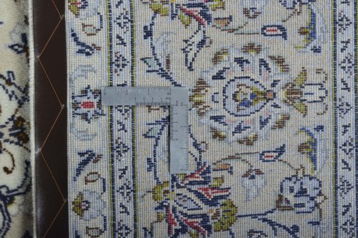 Backside of handmade New Kashan rug showing knot structure and weave density