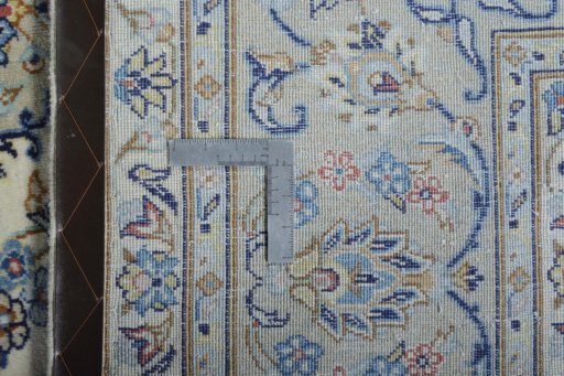 Backside of handmade New Kashan rug showing knot structure and weave density