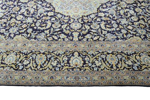 Corner detail of 2000s Kashan rug showing border pattern and Wool pile