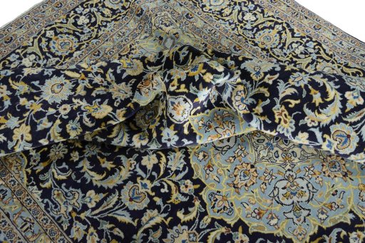 Surface texture of 2000s Kashan rug with natural Wool and intricate pattern