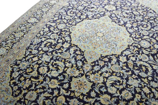 Backside of handmade 2000s Kashan rug showing knot structure and weave density