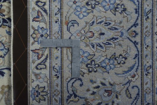 Backside of handmade New Kashan rug showing knot structure and weave density