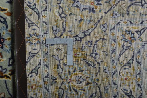 Backside of handmade 2000s Kashan rug showing knot structure and weave density