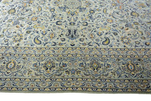 Corner detail of 2000s Kashan rug showing border pattern and Wool pile