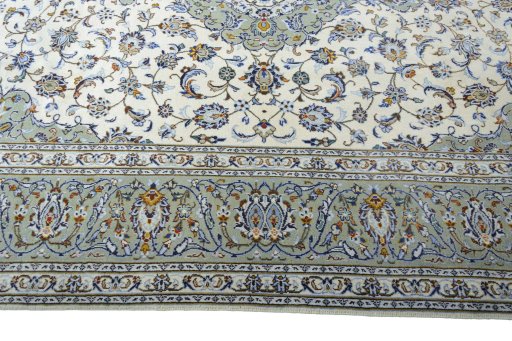 Corner detail of 2000s Kashan rug showing border pattern and Wool pile
