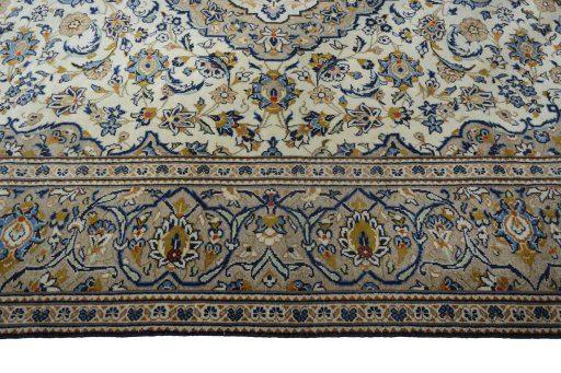 Corner detail of 2000s Kashan rug showing border pattern and Wool pile