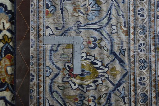 Backside of handmade 2000s Kashan rug showing knot structure and weave density
