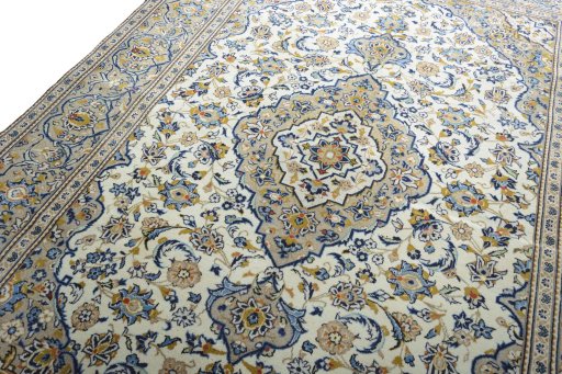 Backside of handmade 2000s Kashan rug showing knot structure and weave density