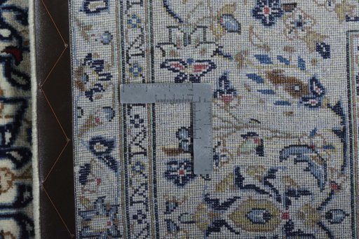 Backside of handmade New Kashan rug showing knot structure and weave density