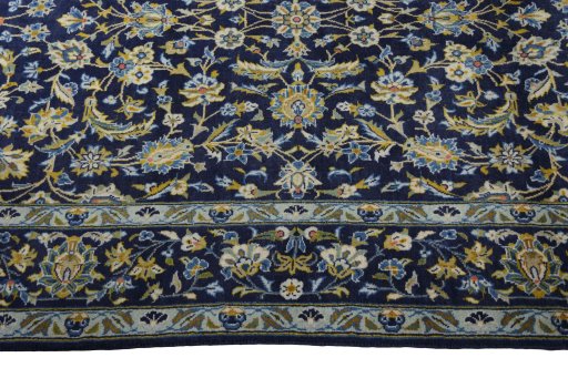 Corner detail of 2000s Kashan rug showing border pattern and Wool pile