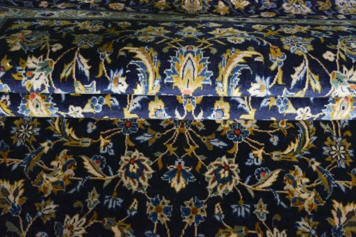 Close-up detail of 2000s Kashan rug from Iran / Persia showing Wool weave