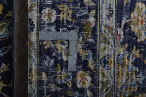 Backside of handmade 2000s Kashan rug showing knot structure and weave density
