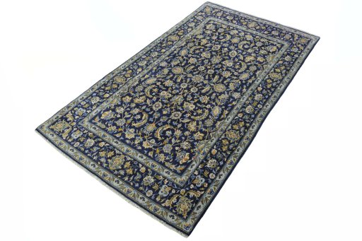 Corner detail of 2000s Kashan rug showing border pattern and Wool pile