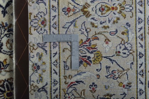 Backside of handmade New Kashan rug showing knot structure and weave density