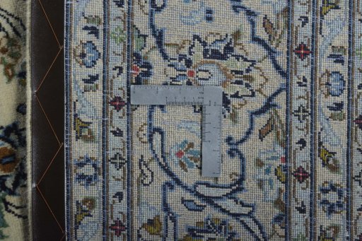 Backside of handmade New Kashan rug showing knot structure and weave density