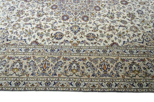 Corner detail of 2000s Kashan rug showing border pattern and Wool pile