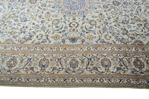 Corner detail of 2000s Kashan rug showing border pattern and Wool pile
