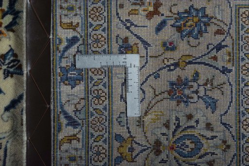 Backside of handmade New Kashan rug showing knot structure and weave density