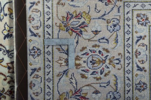 Backside of handmade New Kashan rug showing knot structure and weave density