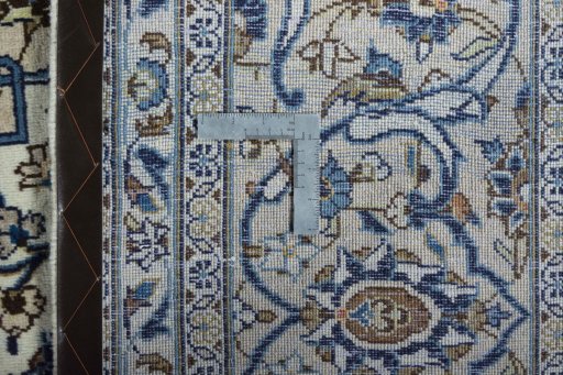 Backside of handmade 2000s Kashan rug showing knot structure and weave density