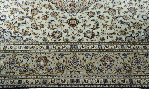 Corner detail of 2000s Kashan rug showing border pattern and Wool pile