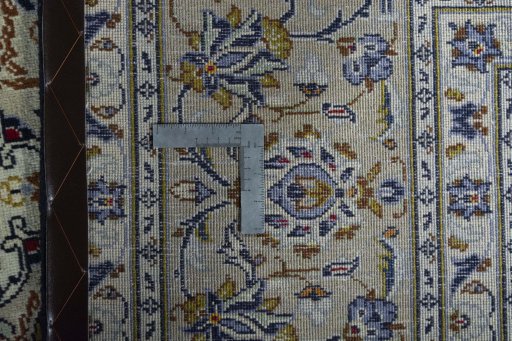Backside of handmade 2000s Kashan rug showing knot structure and weave density