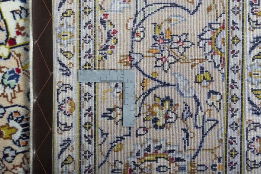 Backside of handmade 2000s Kashan rug showing knot structure and weave density