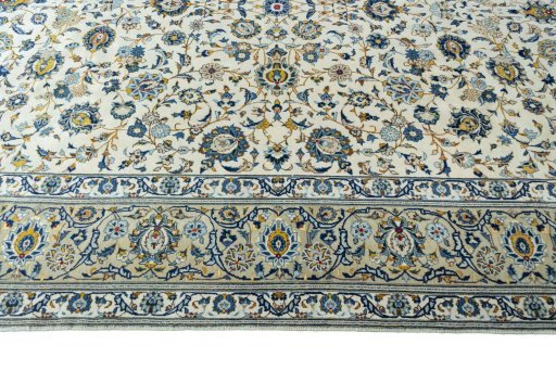 Corner detail of 2000s Kashan rug showing border pattern and Wool pile