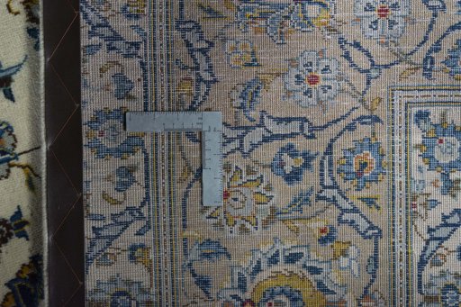 Backside of handmade 2000s Kashan rug showing knot structure and weave density