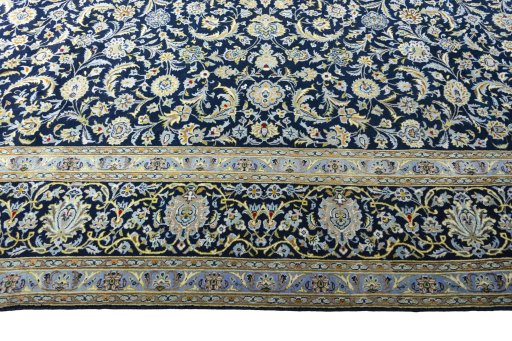 Corner detail of 2000s Kashan rug showing border pattern and Wool pile