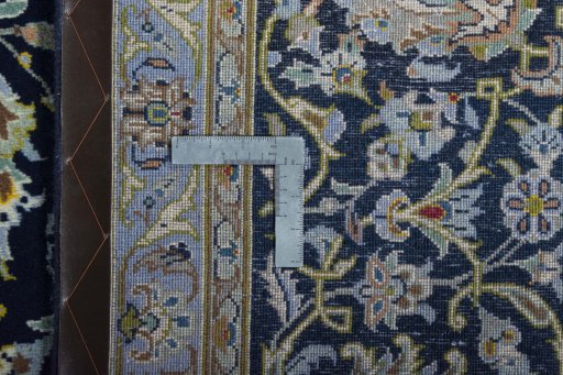 Backside of handmade 2000s Kashan rug showing knot structure and weave density