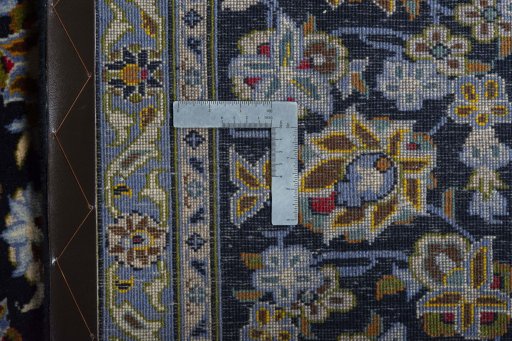 Backside of handmade 2000s Kashan rug showing knot structure and weave density