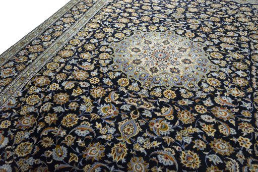 Backside of handmade 2000s Kashan rug showing knot structure and weave density