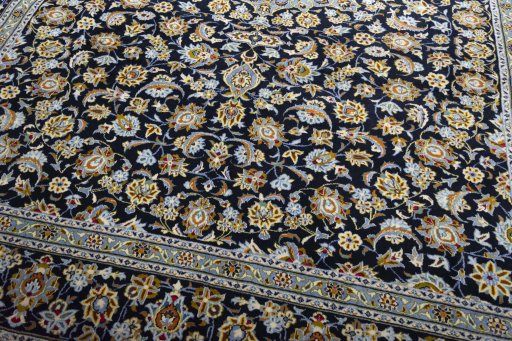 Close-up detail of 2000s Kashan rug from Iran / Persia showing Wool weave