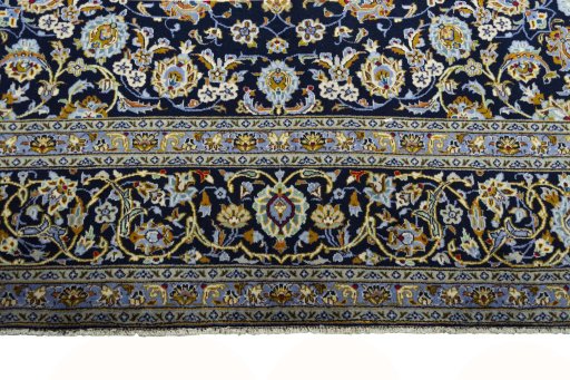 Backside of handmade 2000s Kashan rug showing knot structure and weave density