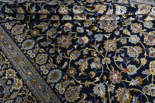 Close-up detail of 2000s Kashan rug from Iran / Persia showing Wool weave