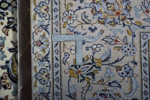 Backside of handmade New Kashan rug showing knot structure and weave density