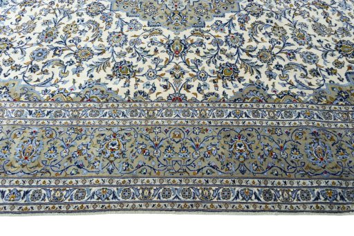 Corner detail of 2000s Kashan rug showing border pattern and Wool pile