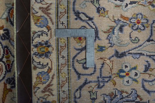 Backside of handmade 2000s Kashan rug showing knot structure and weave density