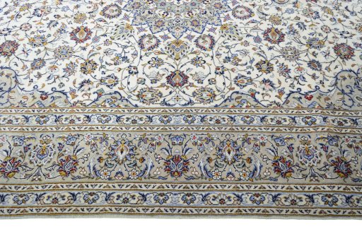 Corner detail of 2000s Kashan rug showing border pattern and Wool pile