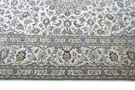 Corner detail of 2000s Kashan rug showing border pattern and Wool pile