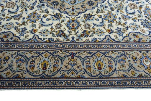 Corner detail of 2000s Kashan rug showing border pattern and Wool pile
